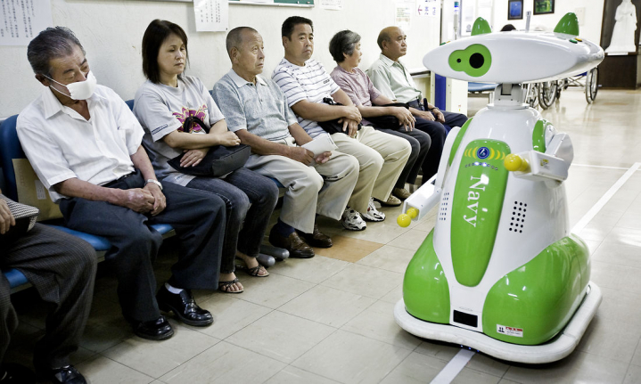 Denne robot, som er fotograferet på kinesisk hospital før corona, viser patienterne vej til elevatoren.